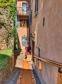 Footpath amidst buildings in city