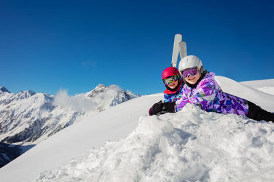 Rear view of woman skiing on snow covered mountain