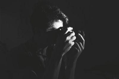 Close-up of hands in black background