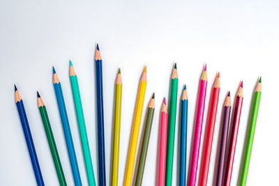 Close-up of colored pencils against white background