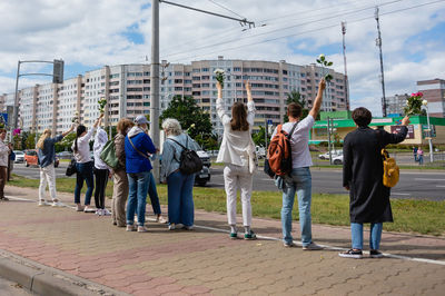 2020 aug 13, belarusian women in white with flowers forming a chain as a form of peaceful protest