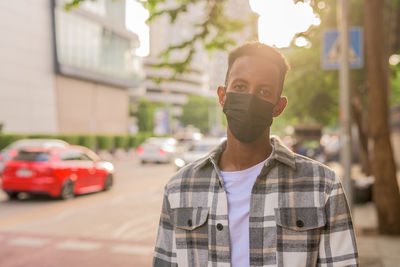 Portrait of young man standing on street