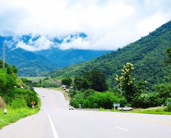 Road amidst mountains against sky