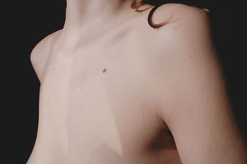 Midsection of shirtless woman