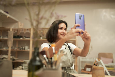 Portrait of young woman photographing