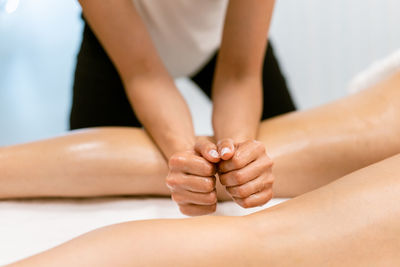 Massage therapist massaging woman at spa