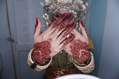 Close-up of brides hand showing henna tattoo