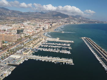 High angle view of buildings by sea against sky