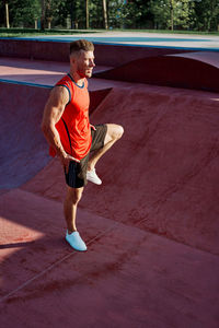 Man exercising while standing outdoors