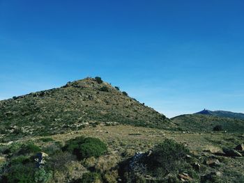 Scenic view of mountains against clear blue sky