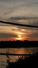 Scenic view of lake at sunset