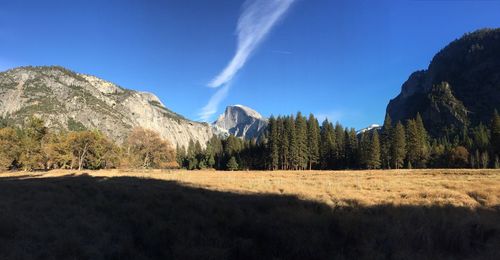 Low angle view of rocky mountains in front of landscape against sky