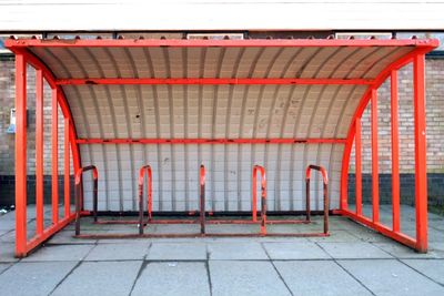 Empty metallic bicycle rack on footpath