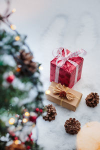 High angle view of christmas present and decorations on wood