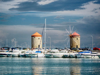 Sailboats moored in harbor