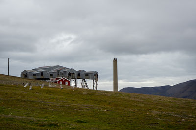Built structure on field against sky svalbard 