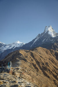 Scenic view of snowcapped mountains against clear sky