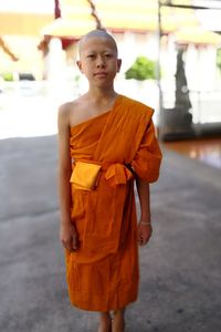 Portrait of monk standing on road