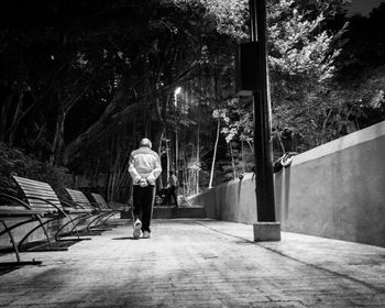 Rear view of man walking on street