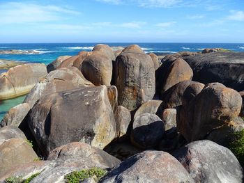 Rocky shore against sky