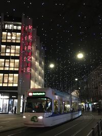 Illuminated city street and buildings at night