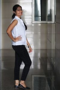 Full length portrait of woman standing on floor