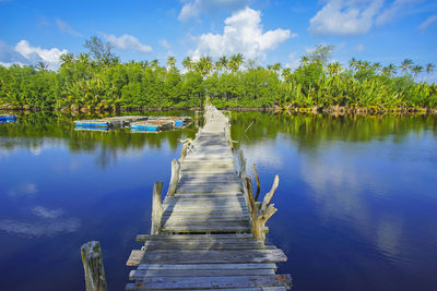 Pier over lake against sky