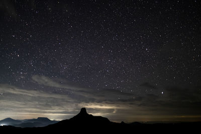 Scenic view of mountains  with stars against sky at night 