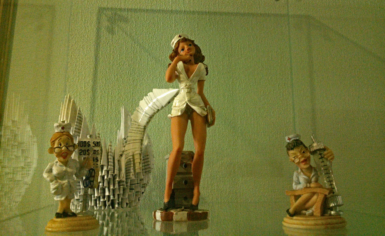Figurines on glass table at home