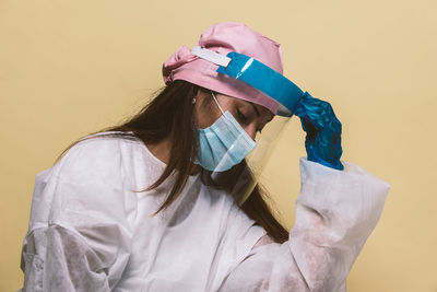 Doctor wearing mask against blue background