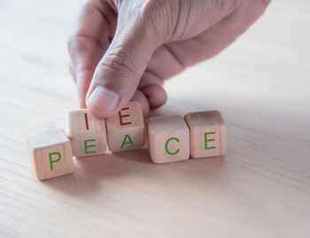 Close-up of hand with toy on table