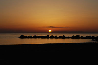 Scenic view of sea against orange sky