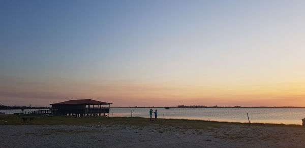 Scenic view of beach against sky during sunset