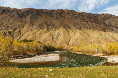 Scenic view of lake and mountains against sky