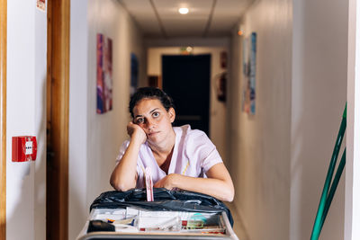 Portrait of young woman sitting at home