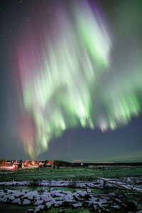 Scenic view of river against sky at night during winter