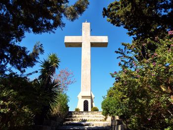 Low angle view of cross against sky