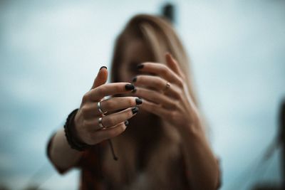 Close-up of woman hands with black nail polish