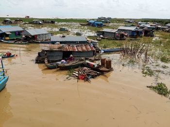 High angle view of boats moored by river against buildings