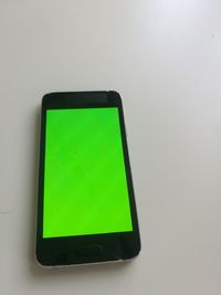 Close-up of mobile phone over white background