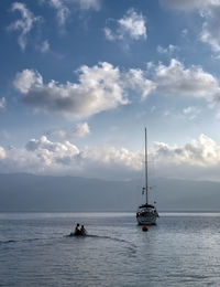 Sailboat sailing on sea against sky