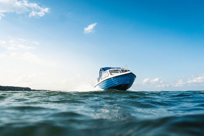 Sailboat sailing in sea against sky