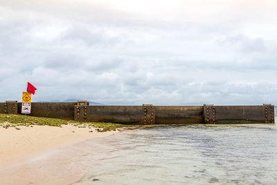 View of beach against cloudy sky