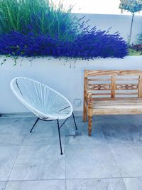 Empty chairs and table against purple wall