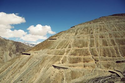 Scenic view of mountains against blue sky