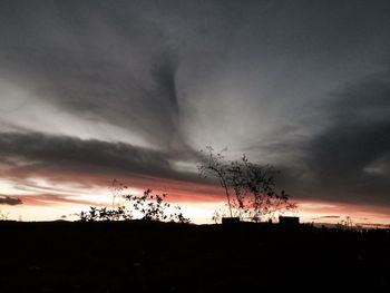 Silhouette of landscape against cloudy sky