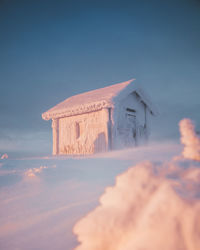 Low angle view of mountain hut against blue sky