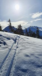 Snow covered landscape against sky