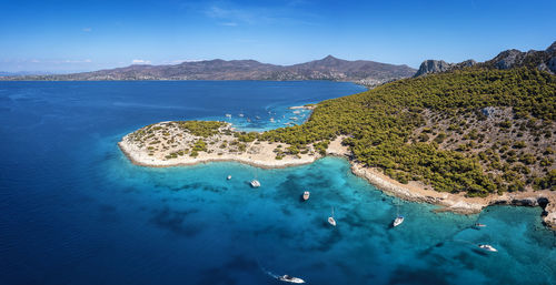 High angle view of bay on shore against blue sky