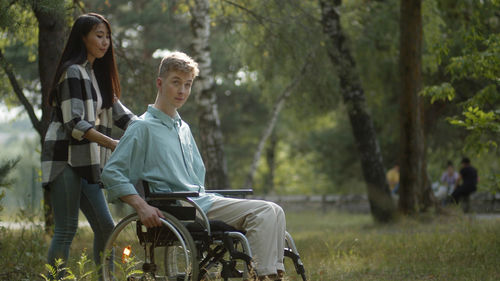 Young woman with handicapped boyfriend at park